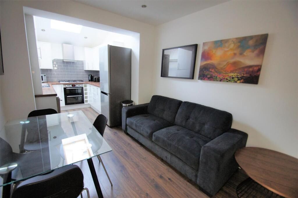 Property photo 1 of 8 A Stylish Living Room Featuring A Comfortable Sofa...