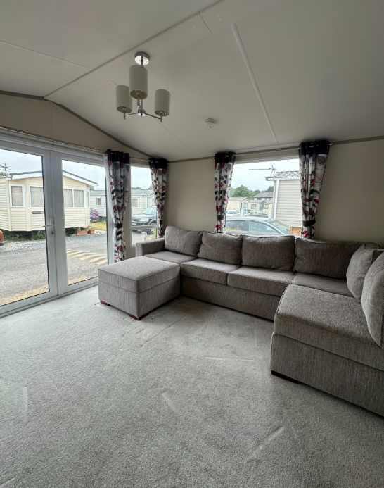 Property photo 2 of 3 Bright Atlas Chorus Lounge Featuring A Large Grey Corner Sofa, Patio Doors And Natural Light