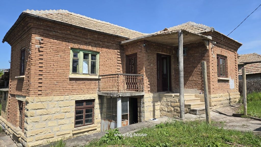 Property photo 1 of 53 Front View Of A Traditional Bulgarian House Showing Stone Base, Brick Walls, Tiled Roof, Small Balcony, And Entrance Porch