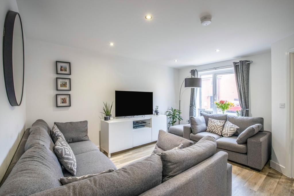 Property photo 1 of 1 A Bright And Cozy Living Room Featuring Ample Seat...