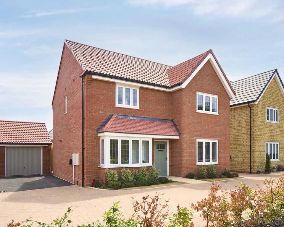 Property photo 1 of 11 A Modern Red Brick House With A Bay Window And A Garage Sits On A Paved Driveway