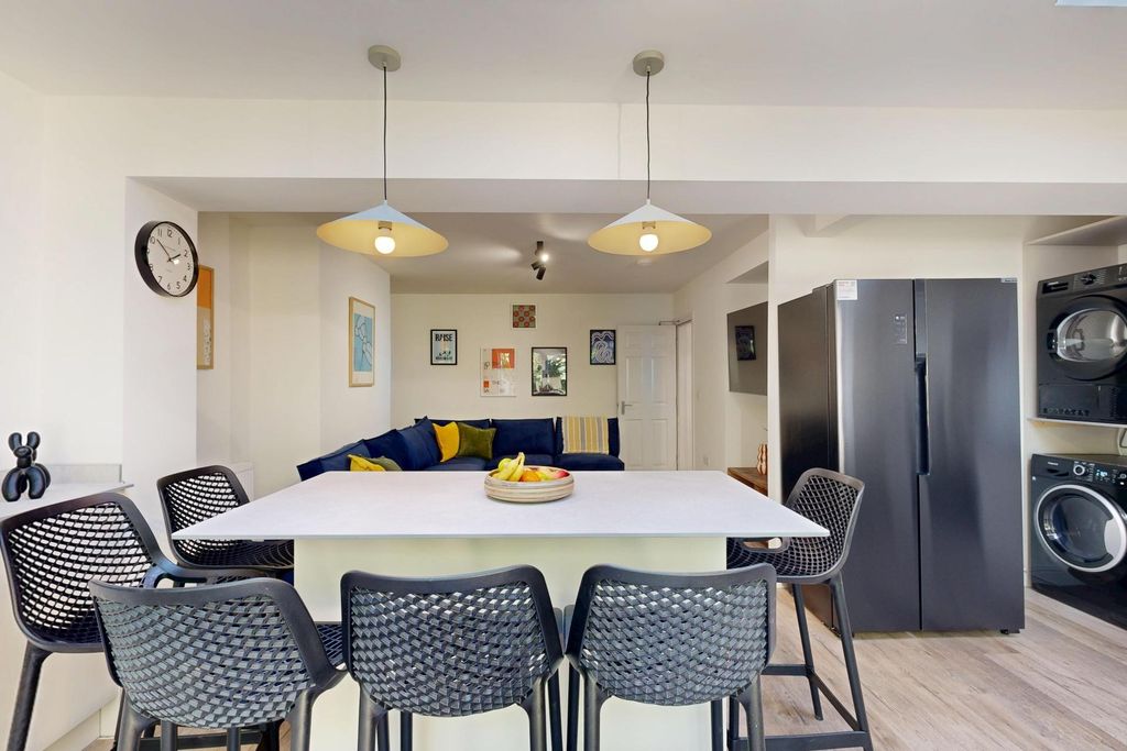 Property photo 2 of 21 A Spacious, Well-Lit Living Room Featuring Modern ...