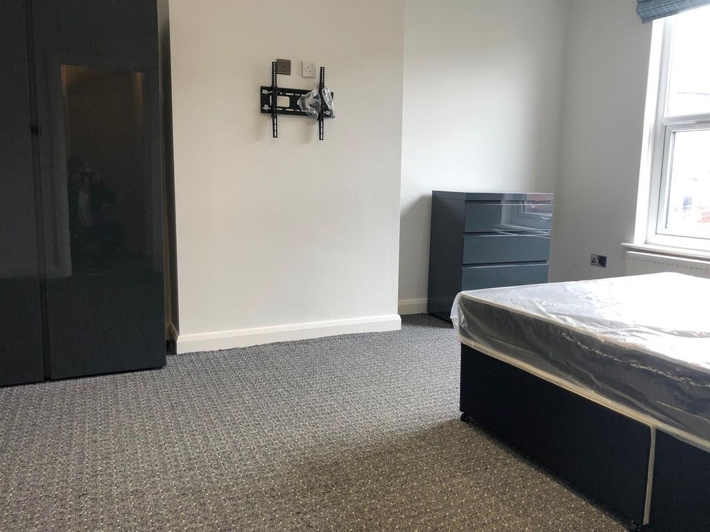 Property photo 3 of 7 A Modest Single Bedroom Featuring A Bed, Window Pr...