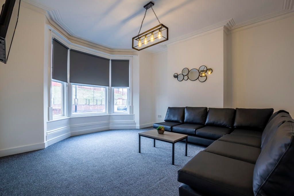 Property photo 2 of 12 A Spacious And Inviting Living Room Featuring A La...