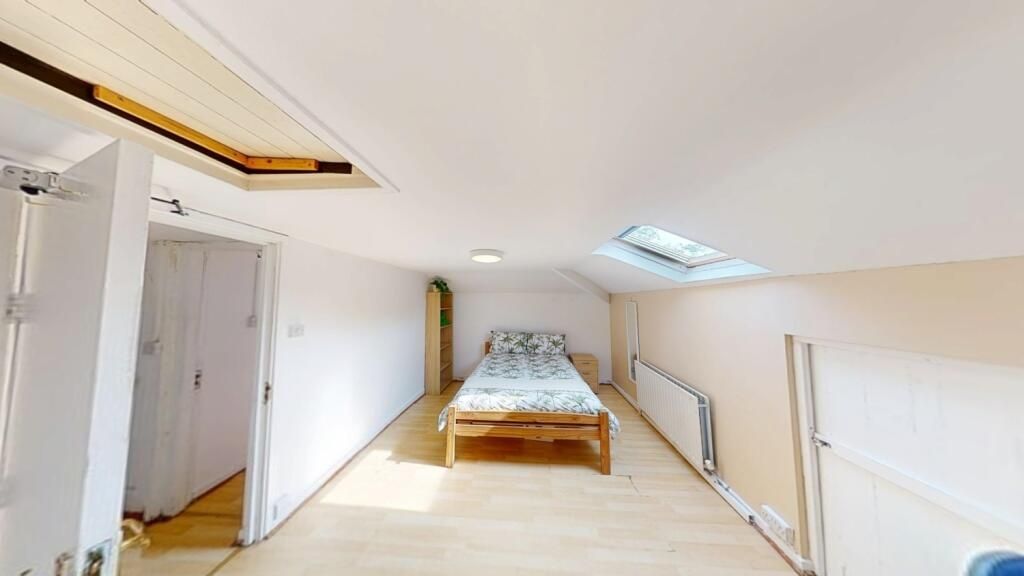Property photo 2 of 15 A Bright Attic Bedroom With A Sloped Ceiling And S...