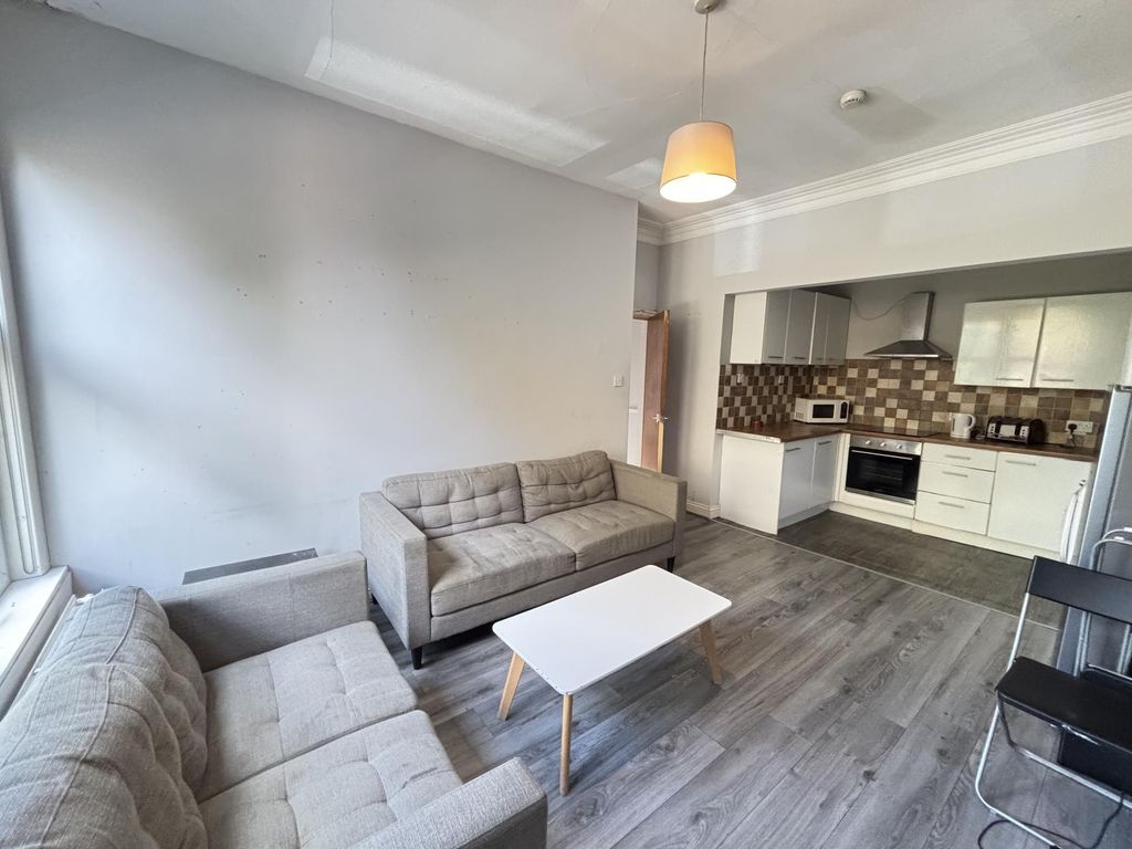 Property photo 3 of 18 A Modern, Well-Lit Living Room With Comfortable Se...