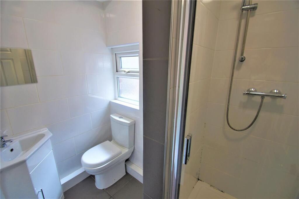 Property photo 2 of 11 Bright And Modern Bathroom Featuring A Spacious Sh...