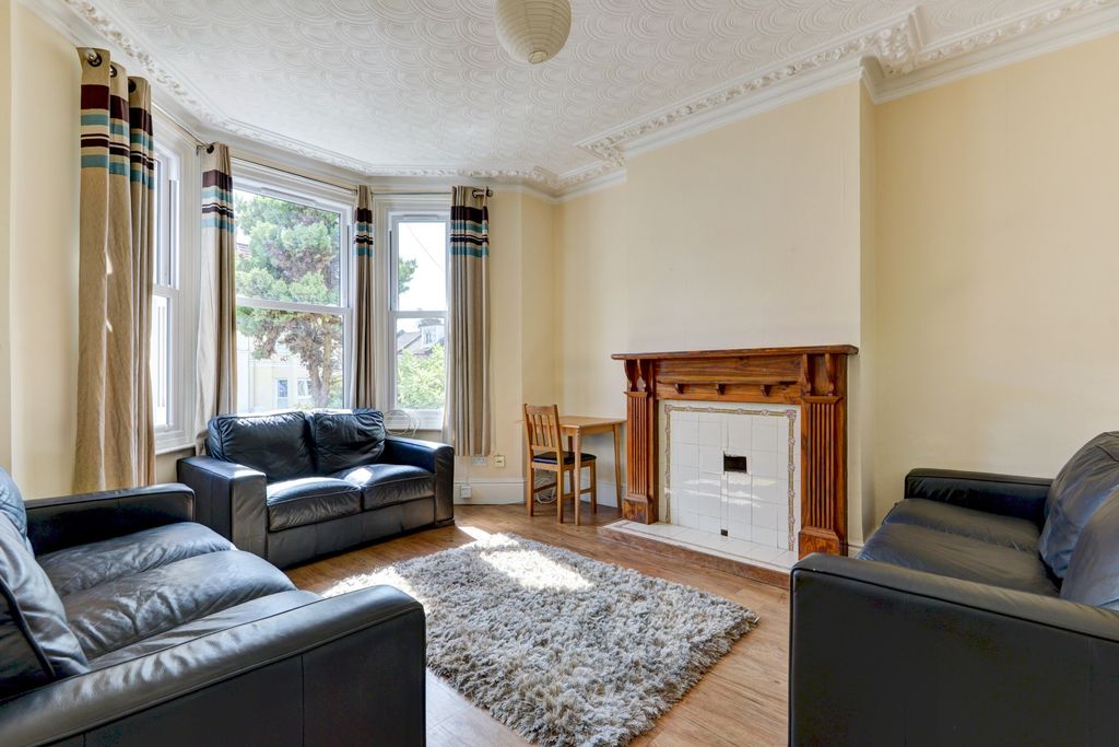 Property photo 1 of 18 A Bright And Inviting Living Room Featuring Three ...