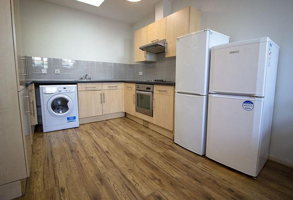 Property photo 2 of 7 A Modern Kitchen Featuring Stylish Cabinetry, Ampl...
