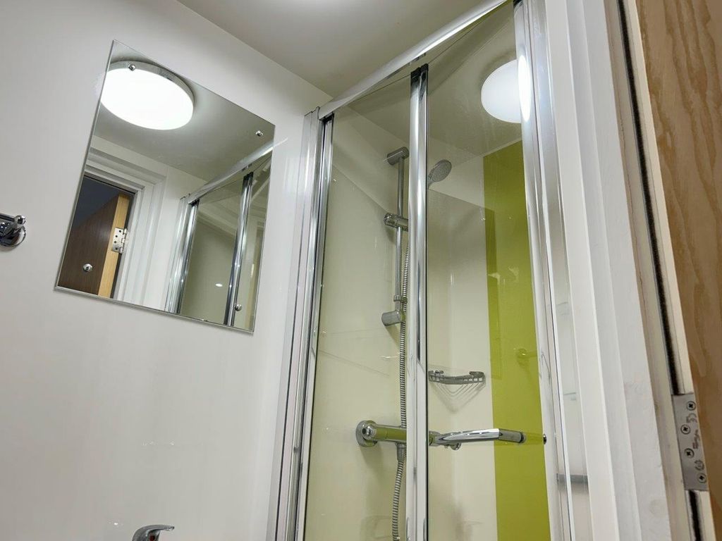 Property photo 3 of 13 Bright Modern Shower With Vibrant Green Accents...