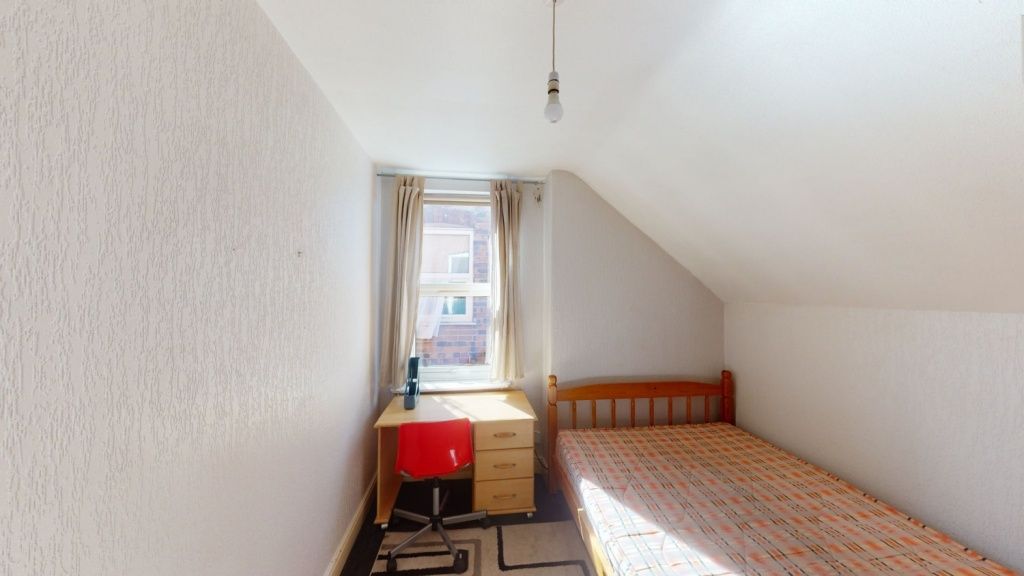 Property photo 1 of 8 A Cozy Single Bedroom With A Wooden Bed Frame And ...