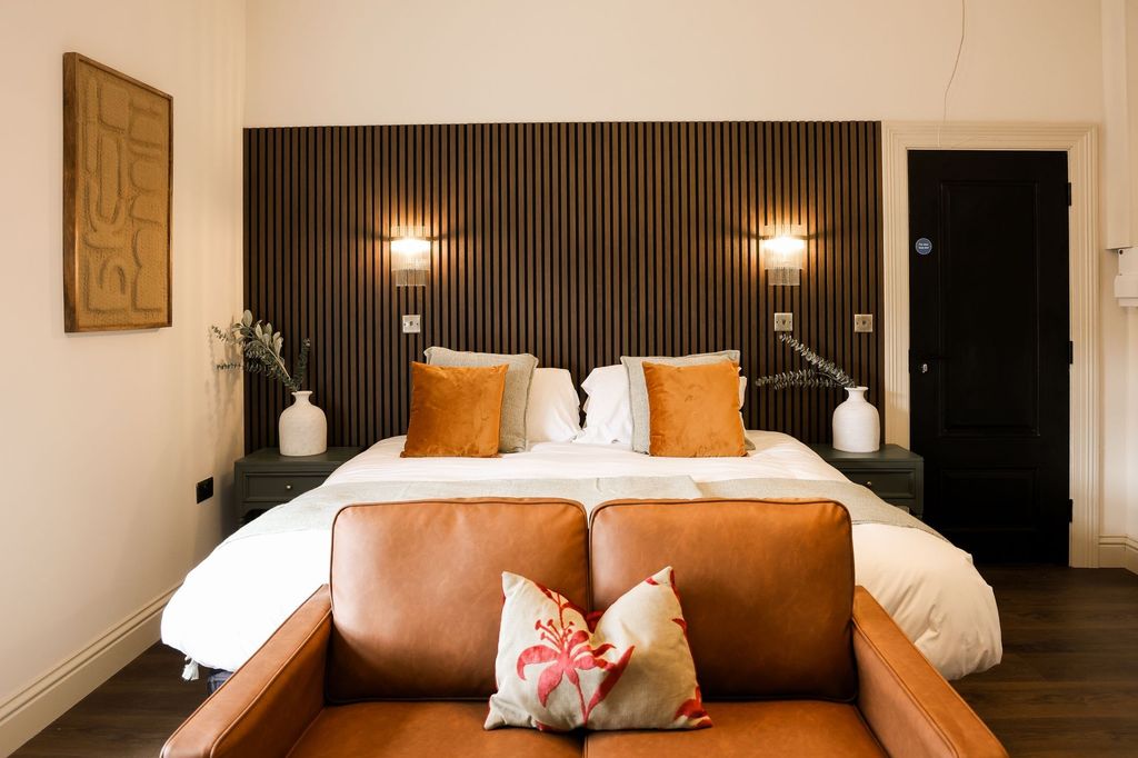 Property photo 2 of 11 Stylish Bedroom With Feature Wall And Plush Sofa...