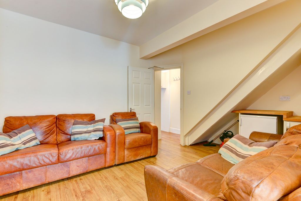 Property photo 3 of 16 A Cozy Living Room Featuring Warm Wooden Flooring,...