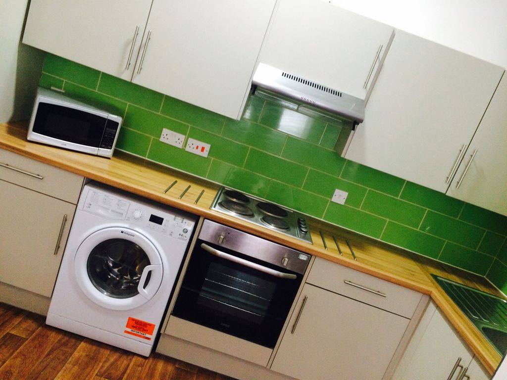 Property photo 2 of 12 This Modern Kitchen Boasts Sleek Cabinetry And A v...