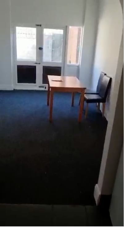 Property photo 3 of 7 A Simple Living Room Featuring A Windowed Door All...