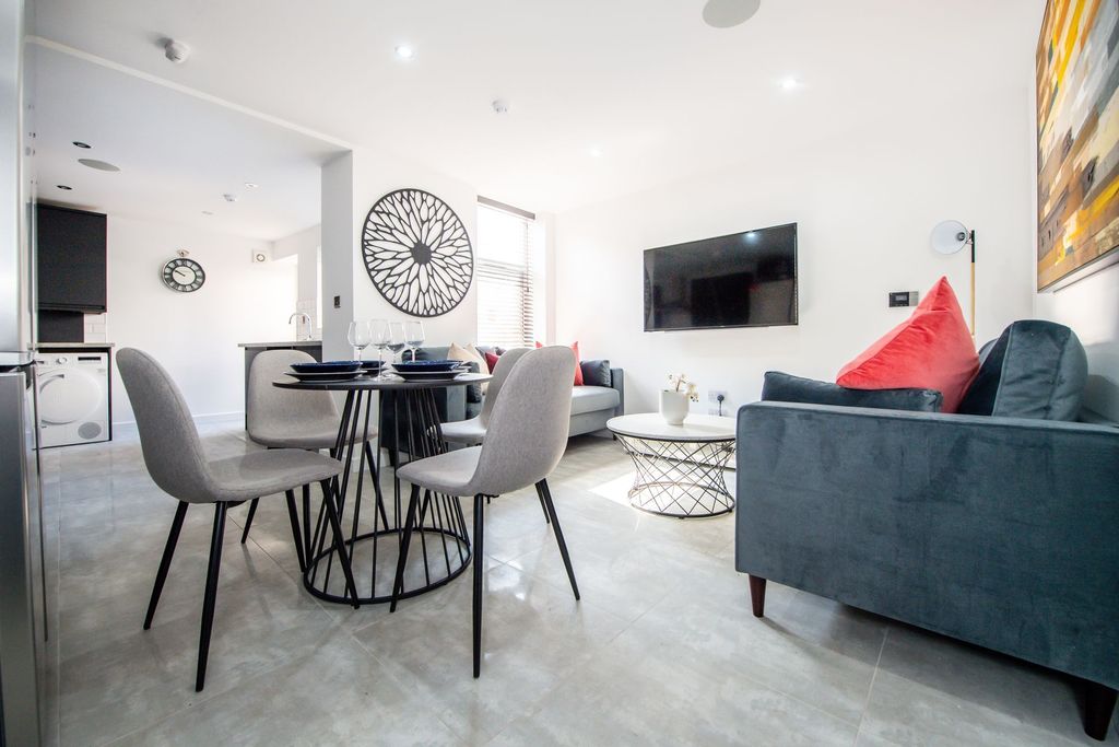 Property photo 1 of 9 Bright And Modern Living Room Featuring A Comforta...