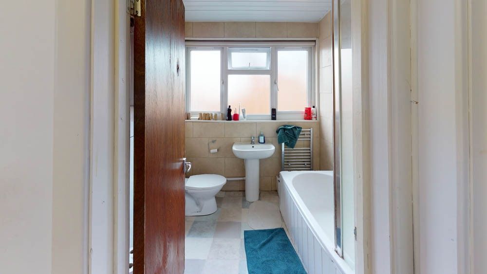 Property photo 2 of 8 A Clean, Well-Lit Bathroom Featuring A Bathtub, To...