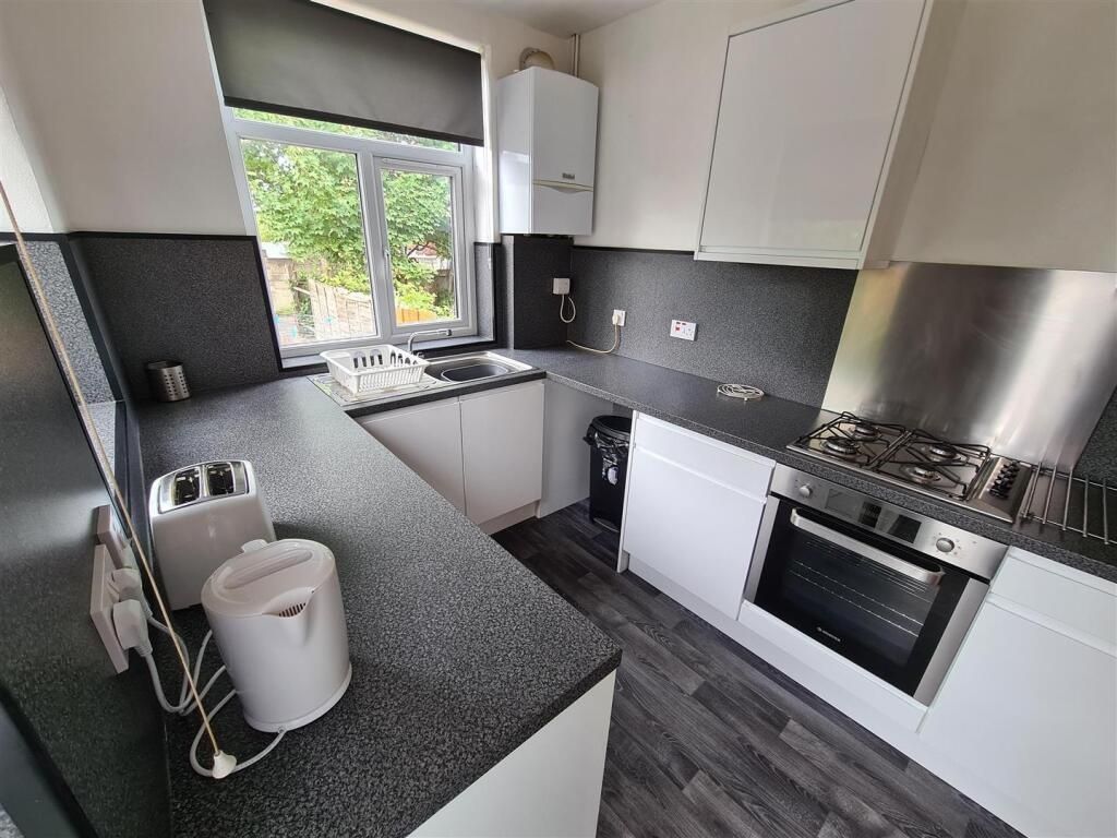 Property photo 2 of 11 Modern Kitchen Featuring Sleek Cabinetry And Ample...
