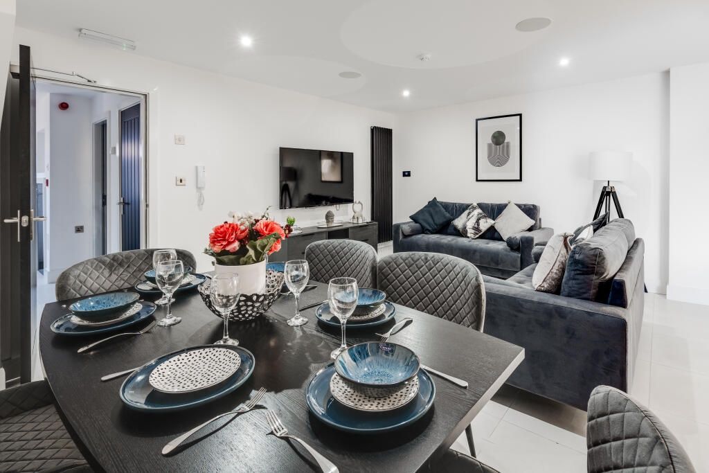 Property photo 3 of 14 A Modern, Well-Lit Living Room Featuring Contempor...