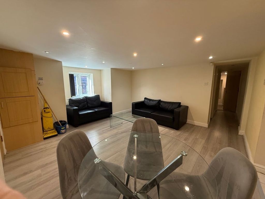Property photo 1 of 9 A Modern Living Room Featuring Sleek Black Sofas A...