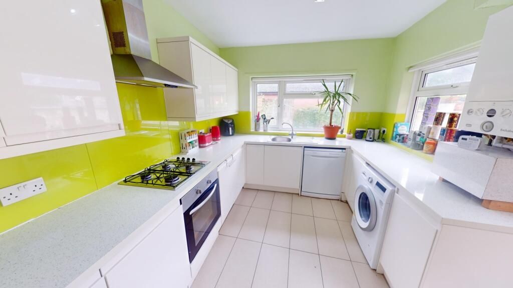 Property photo 3 of 10 Bright And Modern Kitchen Featuring Fresh Green Wa...
