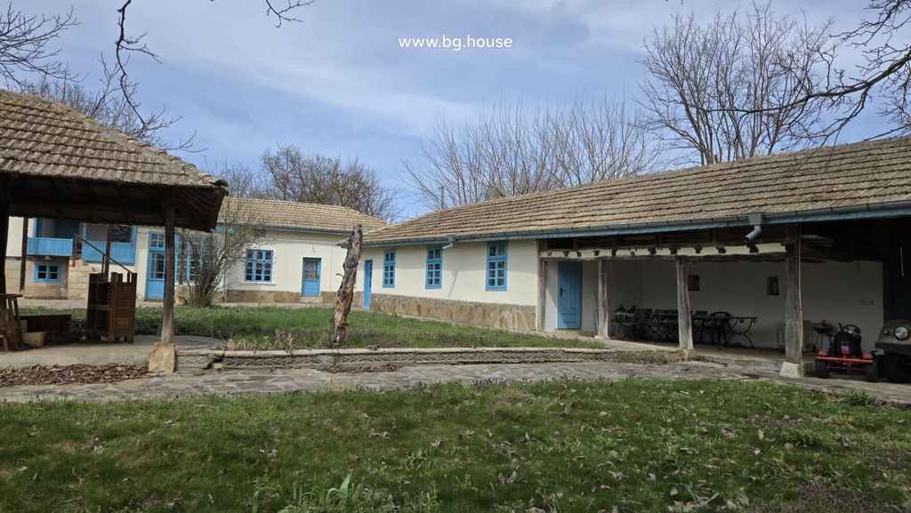 Property photo 1 of 100 Exterior View Of A Traditional Bulgarian House With Blue Doors And Windows And A Tiled Roof Surrounded By Leafless Trees.