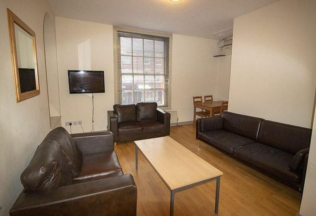 Property photo 1 of 6 Spacious Living Room Featuring Comfortable Leather...