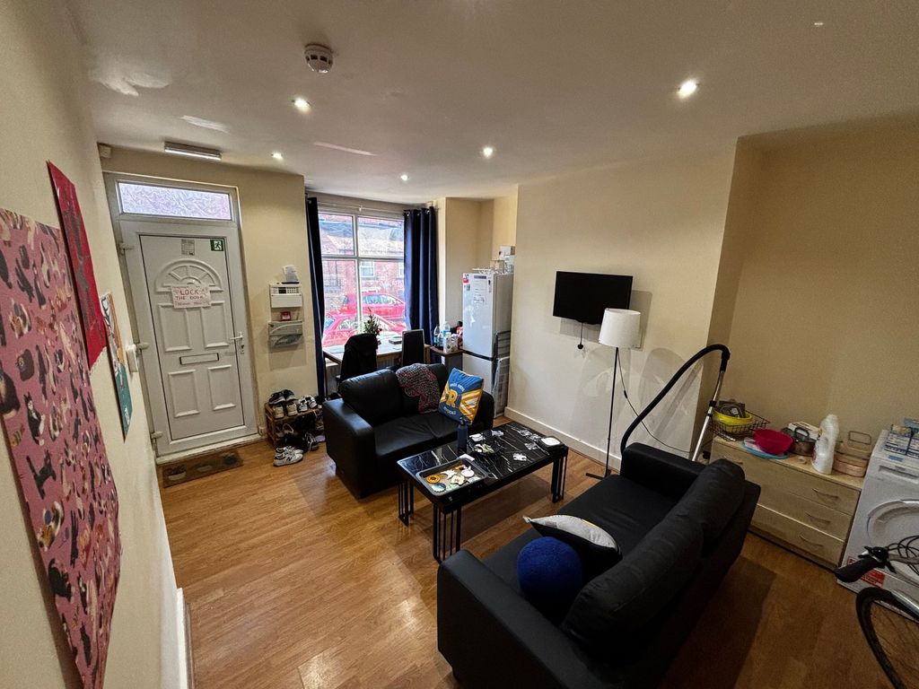 Property photo 2 of 10 Well-Lit Communal Living Area With Two Black Sofas...