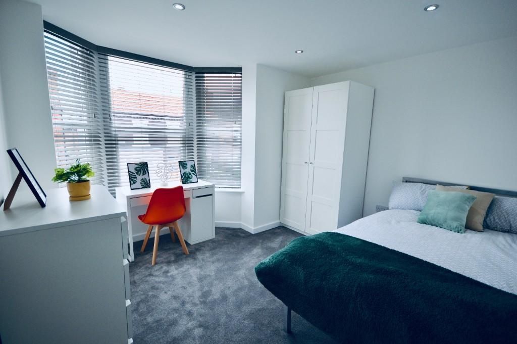 Property photo 1 of 15 A Bright And Tidy Bedroom Featuring A Large Bed Wi...