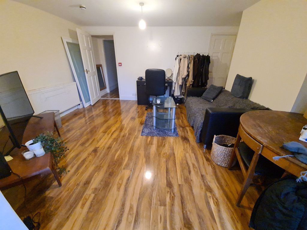 Property photo 1 of 4 Spacious, Open-Plan Living Area With Warm Wood-Eff...