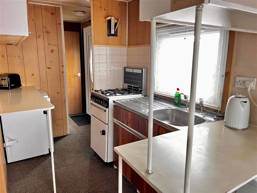 Property photo 1 of 8 Kitchen Area