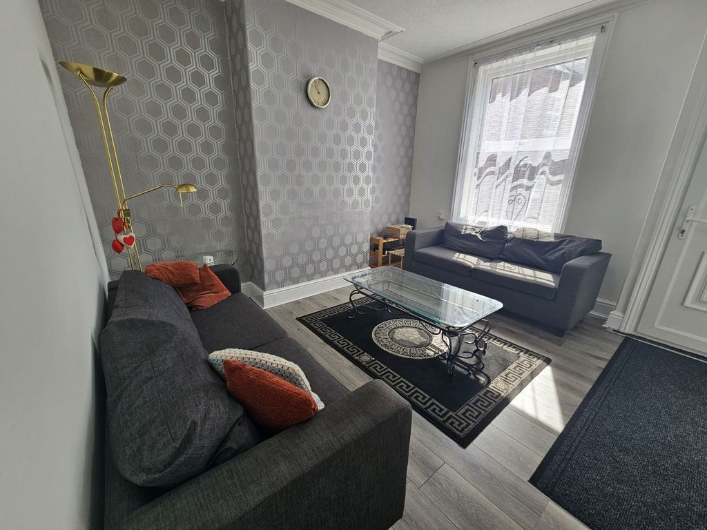 Property photo 1 of 18 A Spacious And Well-Lit Living Room Featuring Comf...