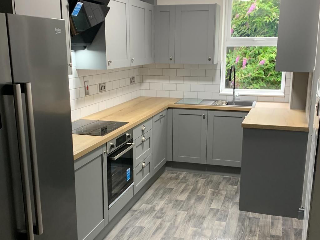 Property photo 3 of 11 Modern Kitchen Featuring Sleek Grey Cabinetry, Spa...