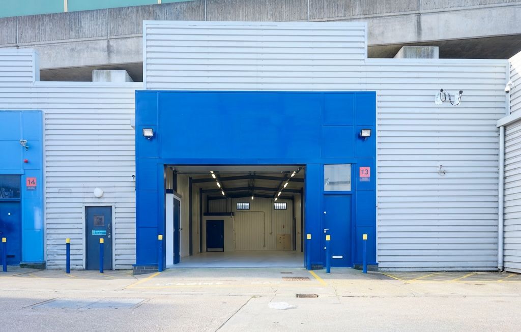 Property photo 1 of 5 The Front Of An Arch With An Open Electric Roller Shutter Entrance Big Enough For Vehicle Access, And Separate Pedestrian Door.
