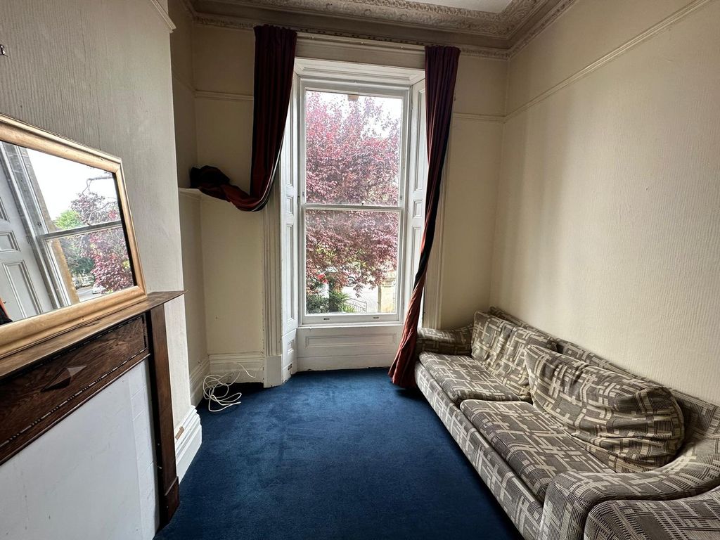 Property photo 3 of 15 A Bright And Inviting Living Room Featuring Large ...
