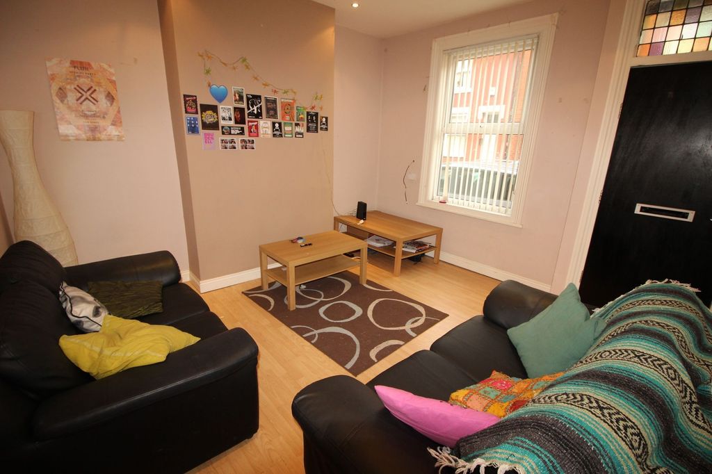 Property photo 3 of 6 A Cozy Living Room Featuring Two Black Leather Sof...