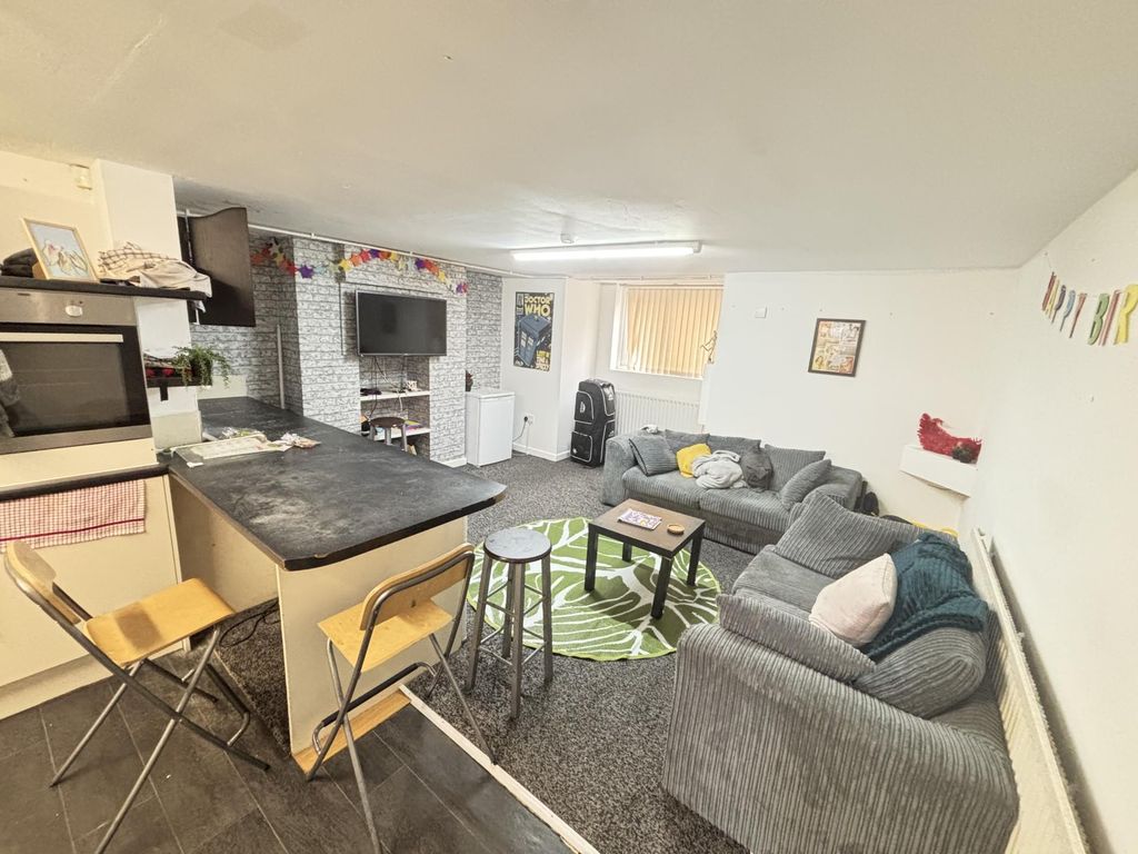 Property photo 2 of 12 A Spacious And Modern Living Room Featuring Comfor...