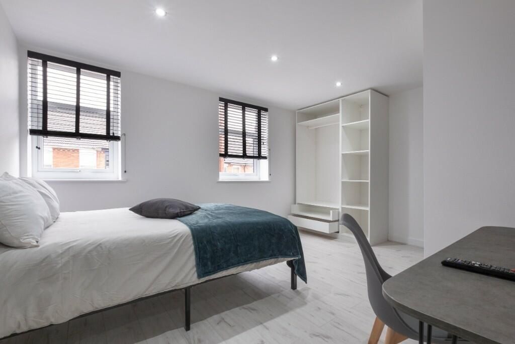 Property photo 1 of 13 A Bright And Tidy Bedroom Featuring A Large Bed, A...