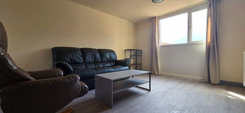 Property photo 1 of 6 A Spacious And Well-Lit Living Room Featuring Comf...