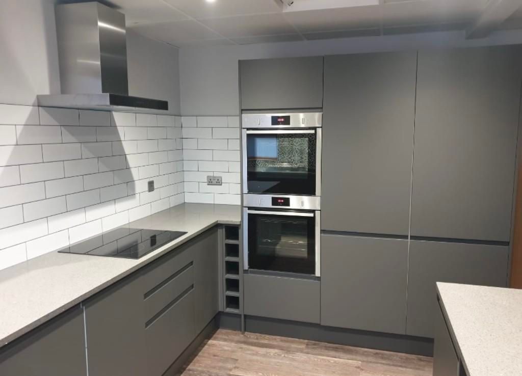 Property photo 3 of 8 A Modern And Sleek Kitchen Featuring Integrated Ap...