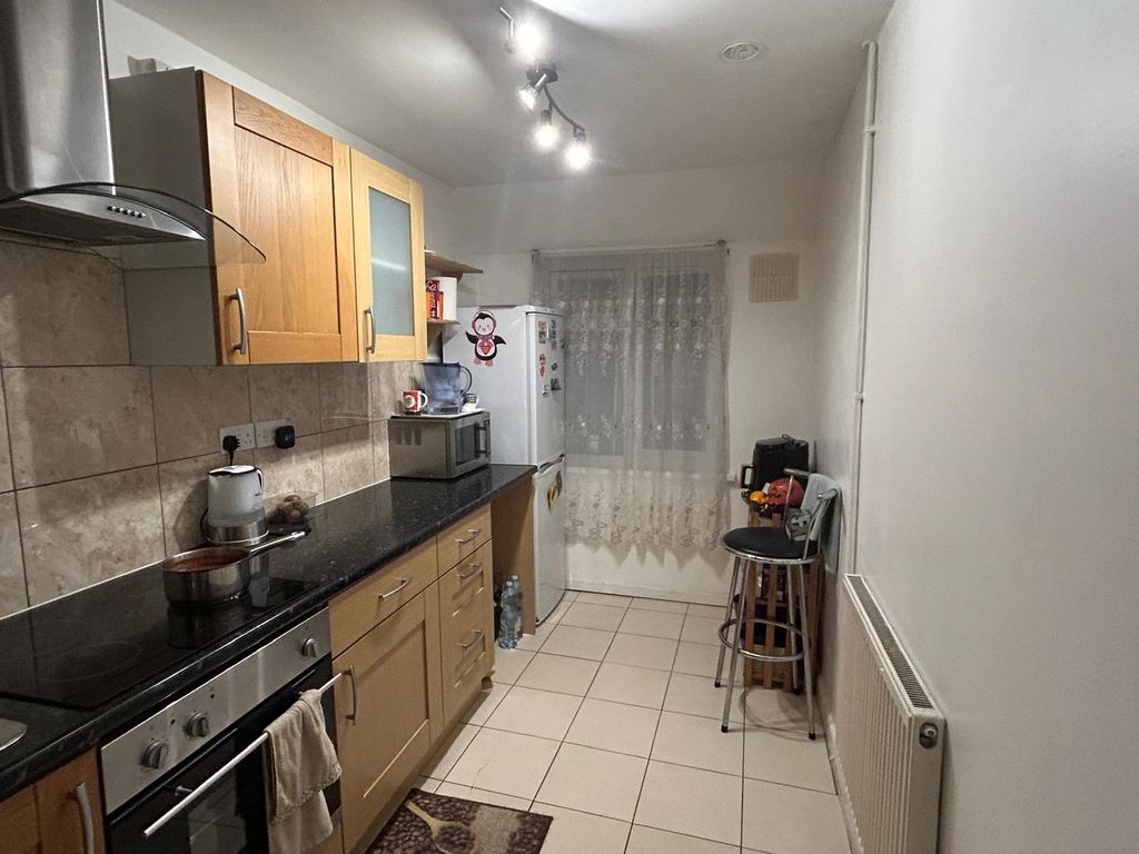 Property photo 3 of 4 Modern Galley Kitchen With Light Wood Cabinets, Bl...