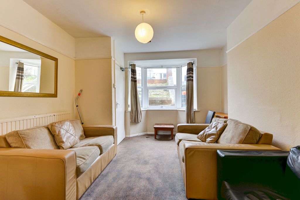 Property photo 2 of 17 A Well-Lit, Cozy Living Room With Comfortable Sofa...