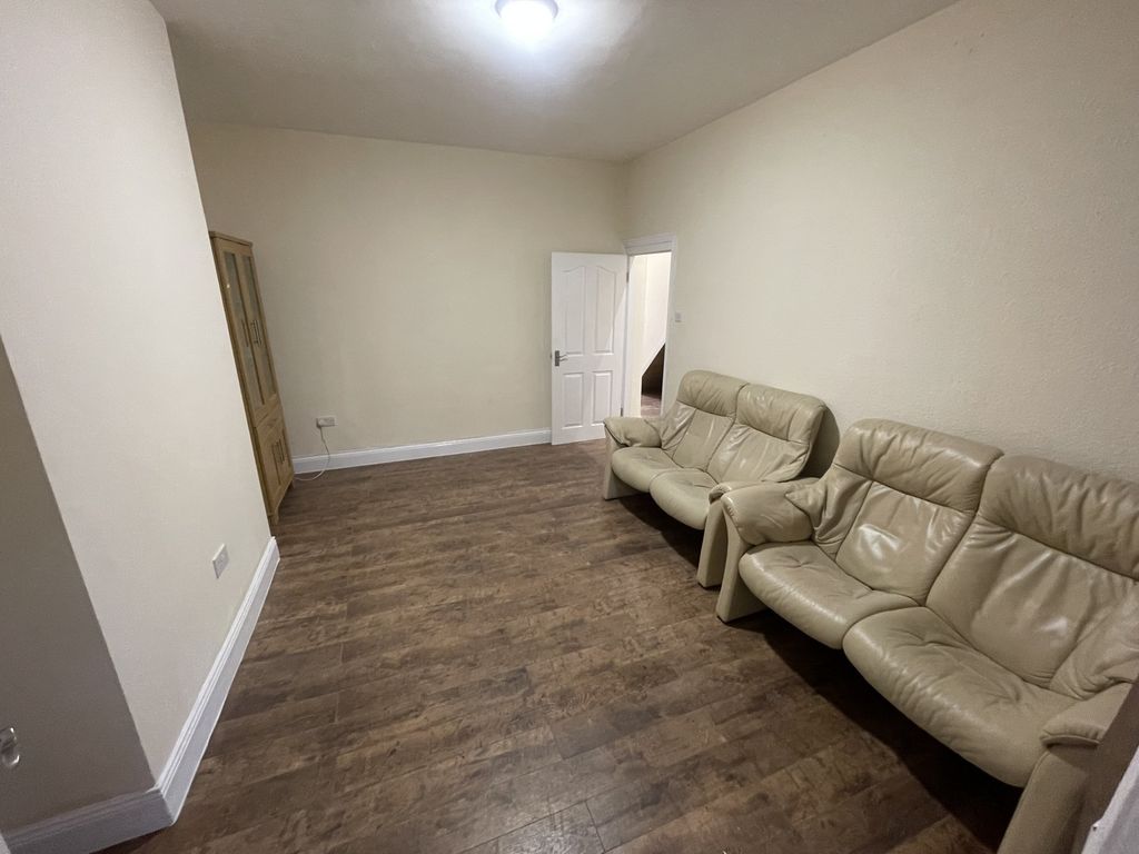 Property photo 3 of 5 A Spacious And Inviting Living Room Featuring Comf...