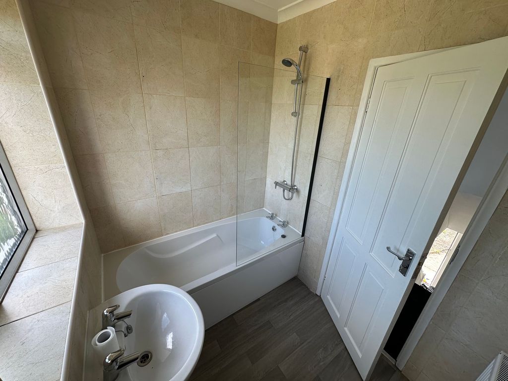 Property photo 3 of 15 Bright And Modern Bathroom Featuring A Clean White...