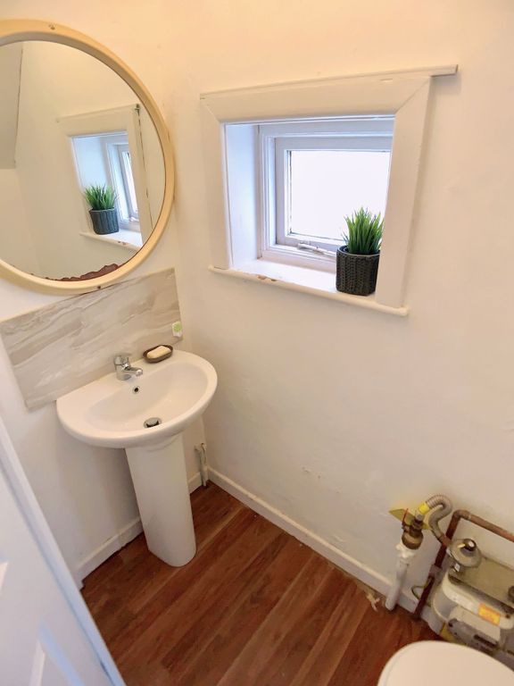 Property photo 2 of 6 A Compact Bathroom Featuring A Small Pedestal Sink...