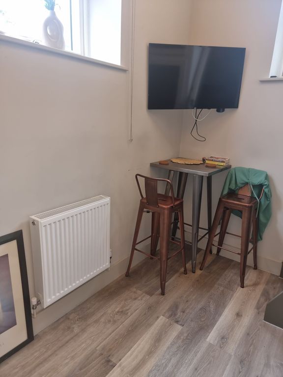 Property photo 3 of 6 Compact Breakfast Nook With Tall Metal Stools And ...