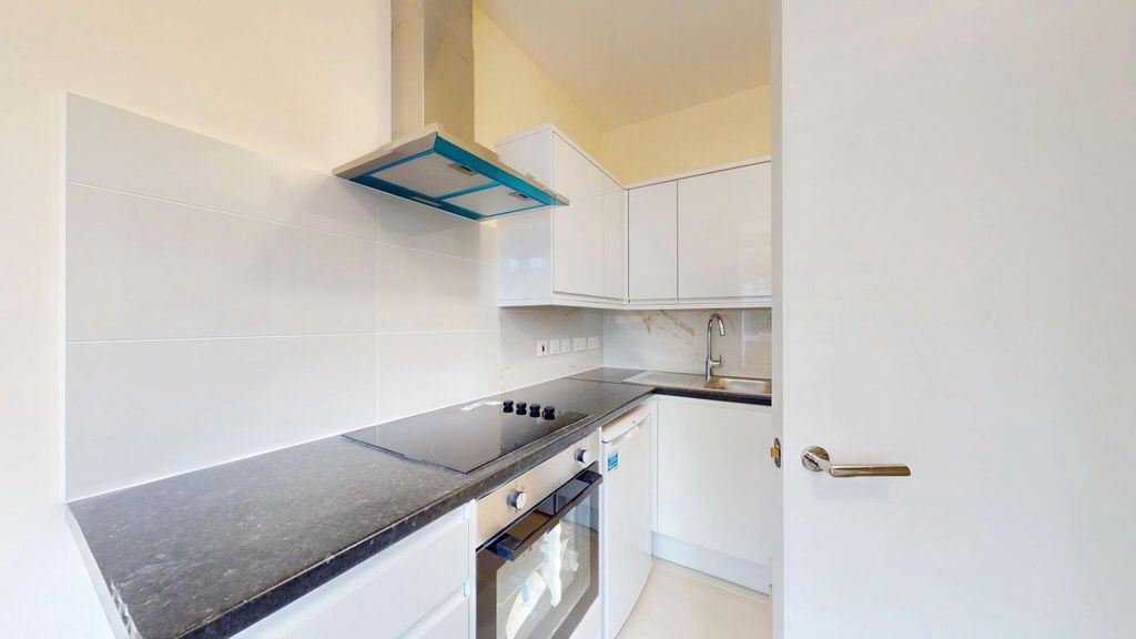 Property photo 3 of 15 Bright, Modern Galley Kitchen With Sleek Black Cou...