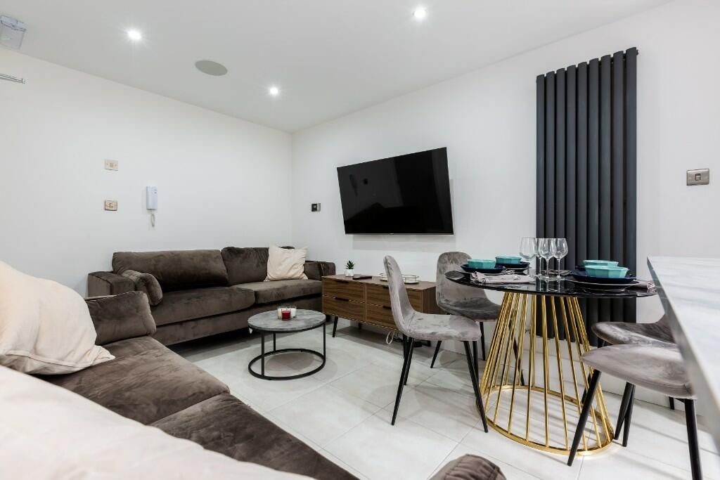 Property photo 3 of 15 A Modern And Spacious Living Room Featuring Comfor...