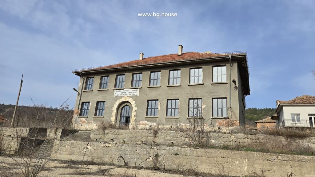 Property photo 1 of 100 Front View Of The Historic School Building Showing Its Symmetrical Windows And Arched Entrance