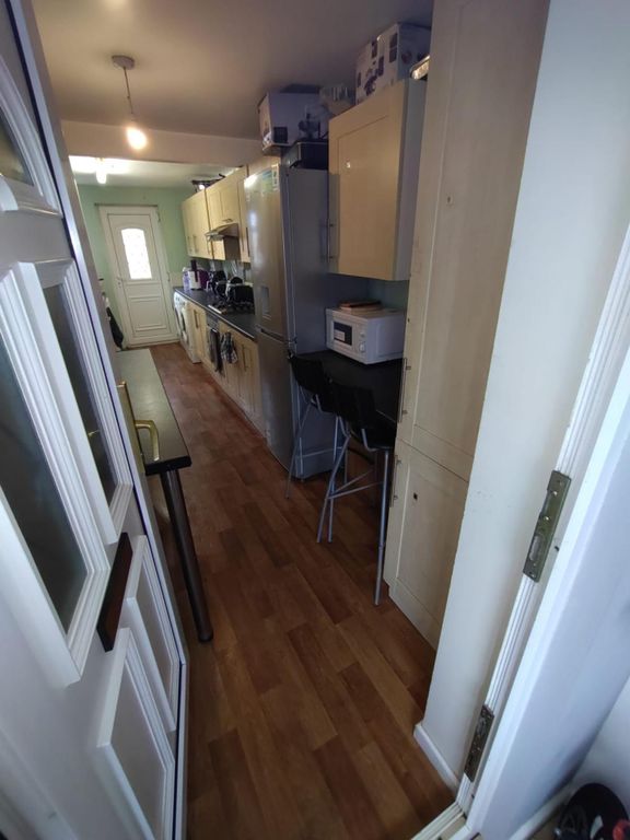 Property photo 3 of 7 This Well-Equipped Kitchen Features Modern Cabinet...